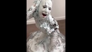 Milf in PVC Catsuit & heels covers her entire body with shaving foam pies
