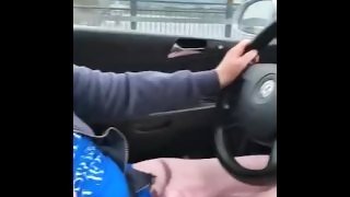 Driving while showing her titties