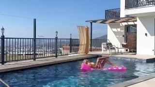 a beautiful blonde masturbates in the pool and lures a peeping guy into a blowjob