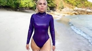 Katerina Piglet is walking on the beach wearing latex body