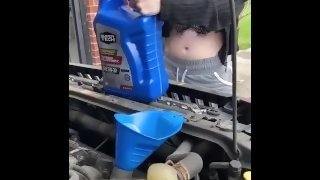 Girl fills oil up in her car and flashes tits