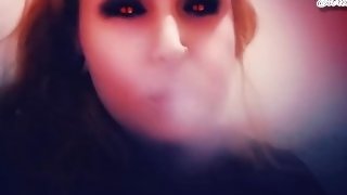 Demon plays with her tits and smokes a cigarette