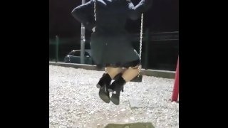 Step mom in stocking and coat swings on the swing and shows the buttplug in her ass