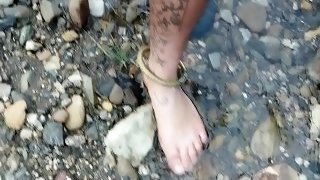 Walking barefoot in the river. Hairy legs. Ankles jewelery.
