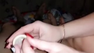 She puts on a condom and sucks her lover in it