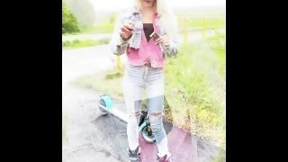 A rollerblade blondie girl is smoking and spitting loogies while smoking a cigarillo