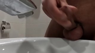 Close up jerking off in a hotel's toilet
