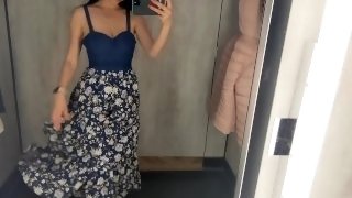 Busty  hot brunette is trying dresses in the store
