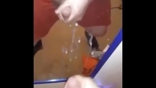 Young stud spraying mirror with cum.