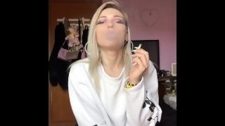 sexy blonde high school girl smokes a cigarette