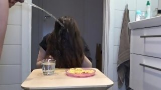 Golden shower on the amateur girl while she is having her breakfast