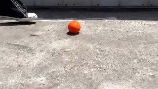Crushing a small tomato and orange