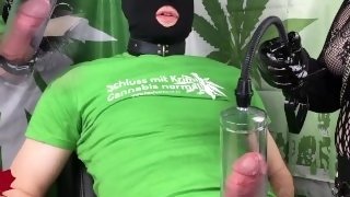 420 Goth MILF handjob in black latex gloves with penis pump. Alternate view.